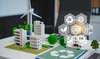 Table top with wind mill, building and other items represnting a sustainable urban landscape