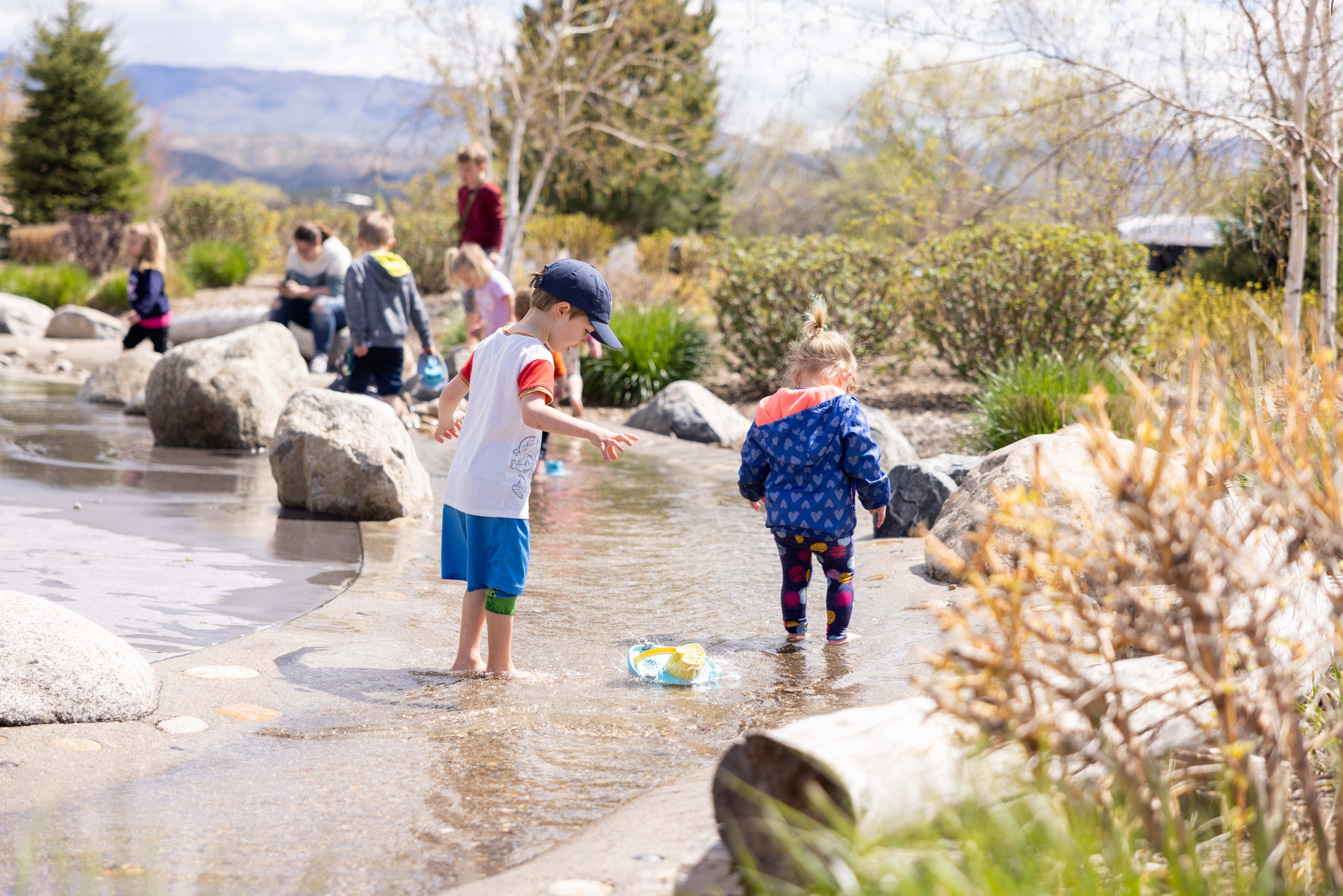 Children playing in The WaterShed's simulated river exhibit.