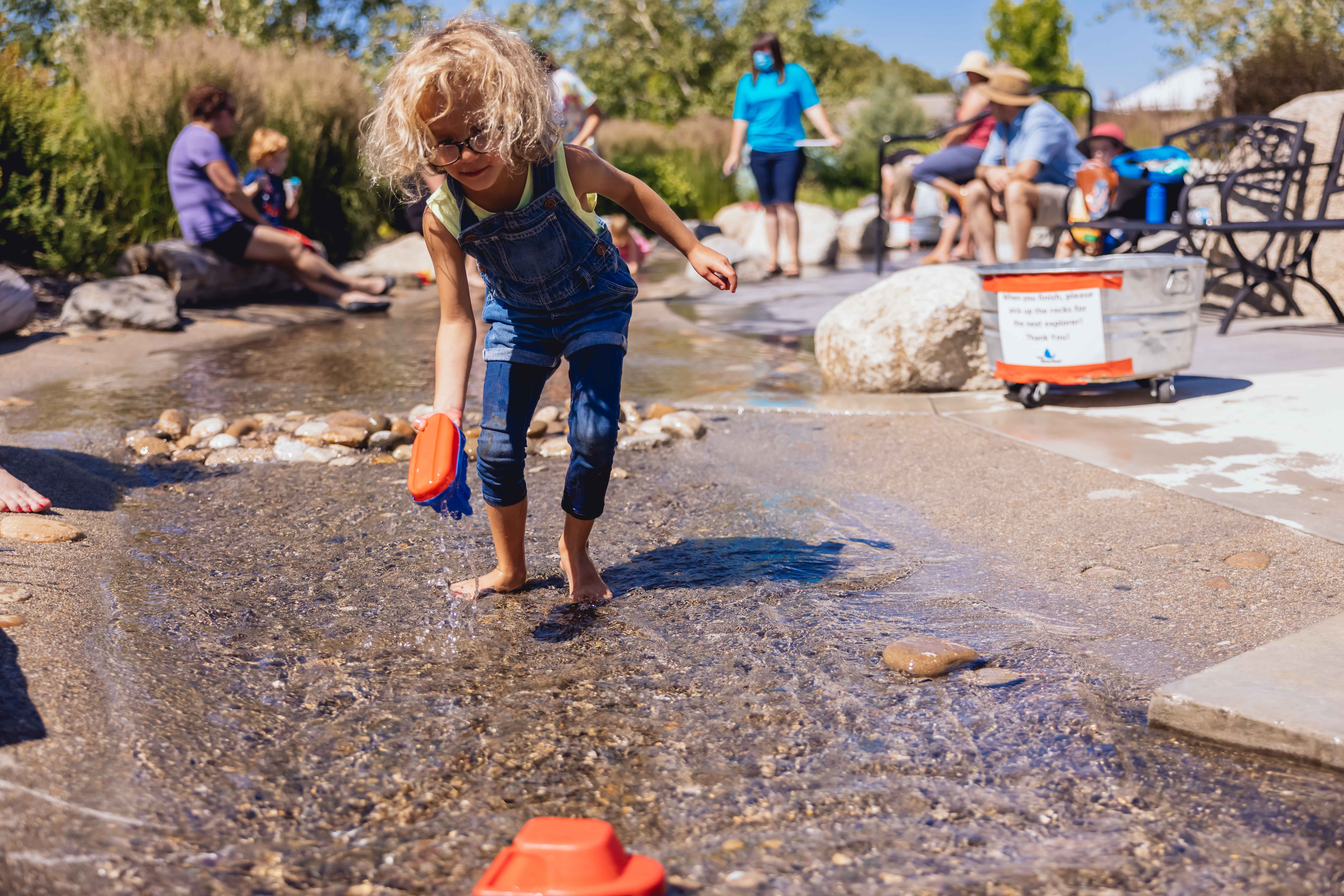 Child playing in the simulated riverbed at the Boise WaterShed.